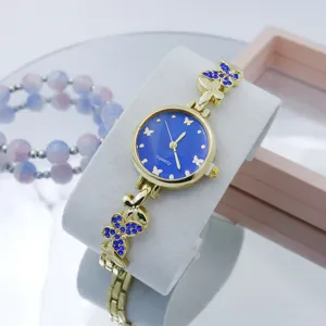 Prachtige dames quartz horloge met blauwe wijzerplaat en vlinder strass metalen band.