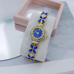 Women's luxury rhinestone quartz watch with blue crystal flower bracelet link design.