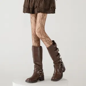 Floral fishnet tights and brown buckle boots detail shot, showing delicate lace mesh.