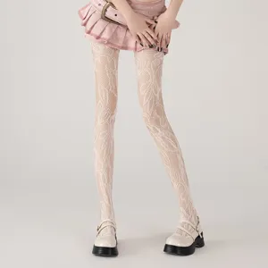 Detail view of white floral lace fishnet stockings, elegant hollow out hosiery for women.