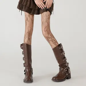 Floral fishnet tights detail shot showing intricate lace pattern paired with stylish boots.