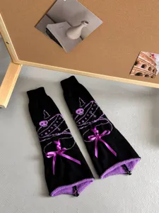 Gothic JK knit leg warmers with purple skull pattern and velvet bow detail close-up