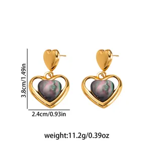 Detailed view of gold stainless steel heart earrings featuring a dark cat-eye stone center.