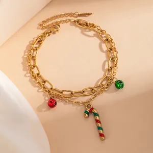 Bracciale natalizio a strati dorato con ciondoli a forma di bastoncino e campanelle, acciaio.