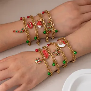 Christmas charm bracelet set featuring enamel tree, gift and snowflake designs in gold tone.