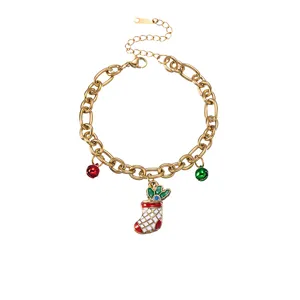 Close-up of gold Christmas charm bracelet with enamel stocking and colorful bells.