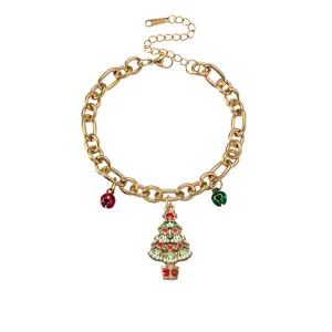 Detailed view of Christmas tree enamel pendant and bells charm on chunky gold chain necklace.
