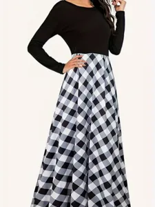 Detail view of an elegant long-sleeved dress with black top and a black and white checkered skirt