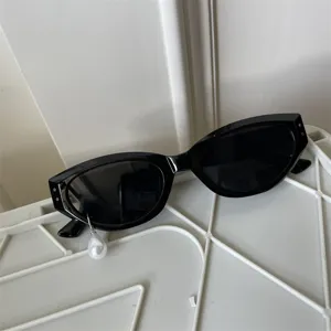 Detailansicht der trendigen schwarzen Cat-Eye Sonnenbrille mit einzigartiger Perle.