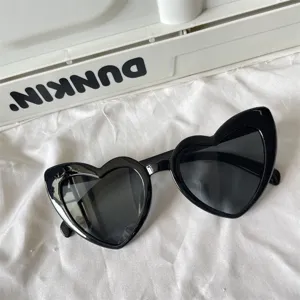 Detailaufnahme von trendigen schwarzen Herz Sonnenbrillen, schicke Retro Katzenaugen.