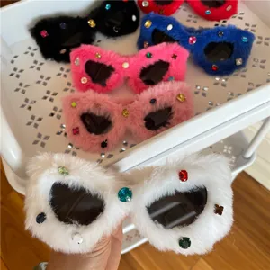 Close-up detail of fluffy rhinestone sunglasses in various vibrant colors for party wear.