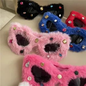 Detailed view of stylish furry cat-eye sunglasses adorned with colorful rhinestones and plush trim.