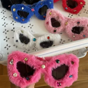 Detail shot of fluffy cat-eye rhinestone sunglasses in vibrant colors for party fashion wear.