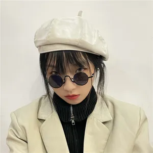 Classic retro round black sunglasses detail shot, vintage metal frame trendy eyewear style.