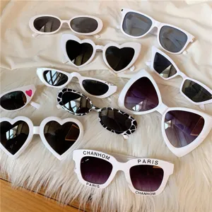 White Harajuku vintage sunglasses set, various shapes like heart, cat-eye and oval styles.