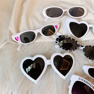 Trendy white Harajuku sunglasses set, featuring retro oval, heart, and cow print frame designs.