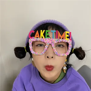Fun birthday party glasses with colorful letters and sprinkles, perfect for celebration photos.