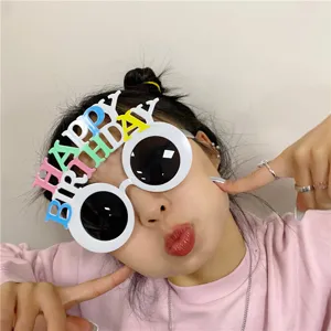 Close-up of funny birthday party sunglasses with colorful letters for celebration.