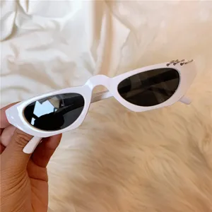 White retro narrow cat-eye sunglasses with metal ring details, trendy Y2K sun eyewear.