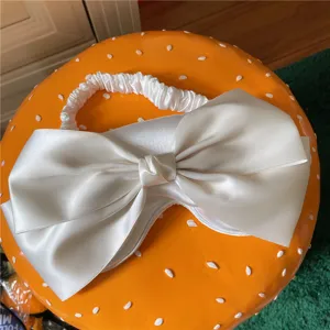 Masque de sommeil blanc en satin avec nœud, doux et respirant pour des nuits paisibles.