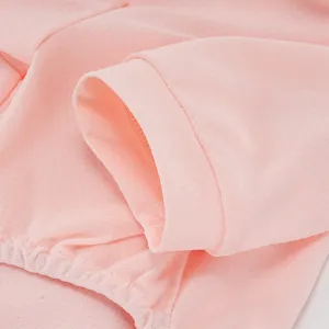 Pink breathable ice silk pet clothing detail shot, soft and comfortable dog apparel fabric.