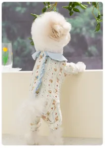 Detailed shot of a cute pet wearing a soft gauze four-legged dog onesie with sweet bear print.