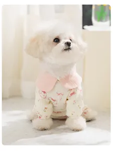 Detail shot of the cute puppy four-legged gauze clothes with pink collar and cartoon prints.