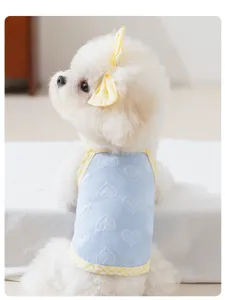Close-up of small dog summer clothes with blue heart embossed texture and yellow gingham trim.