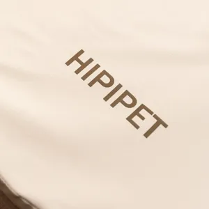 Close-up detail of the premium pet bed leather fabric surface featuring brand logo.