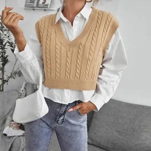 Detail shot of women's cable knit V-neck sweater vest layered with white shirt for style
