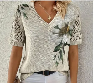 Beige V-neck knit sweater featuring elegant floral print and hollow-out short sleeves for women.