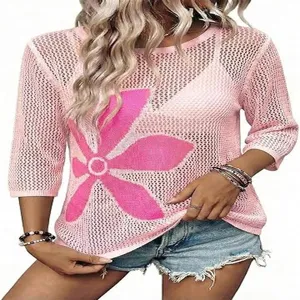 Maglione in maglia traforata con scollo rotondo, maniche a tre quarti e audace motivo floreale.
