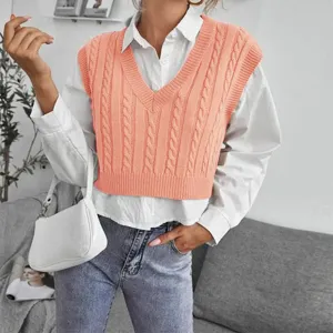 Cable knit V-neck sweater vest layered with white shirt, stylish daily apparel detail.