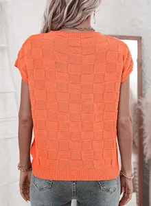 Detailed view of the vibrant orange textured checkerboard knit top showcasing the back design and fabric.