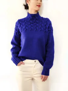 Royal blue high neck cable knit sweater worn by female model for daily winter fashion