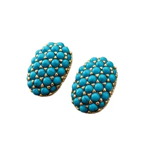 Boucles d'oreilles vintage ovales en turquoise avec clous dorés, style chic et élégant.