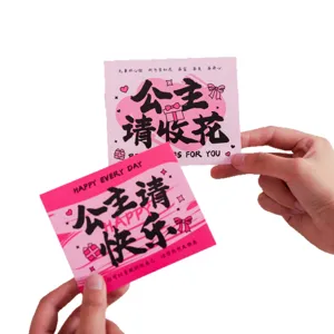 Pink flower greeting card gift box decoration message card held in hands for Valentine's day.
