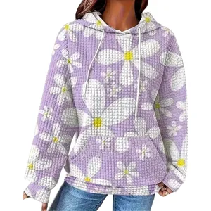 Detalle en primer plano de la sudadera con capucha de punto gofrado y margaritas