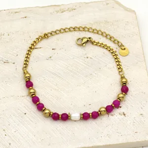 Detail of stainless steel bracelet with magenta stone beads and a freshwater pearl