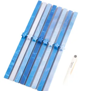 Fresh gradient star origami paper strips set with handmade lucky stars and a white prop pen.
