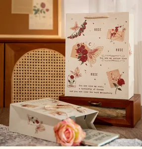 Vintage rose butterfly paper gift bag, detailed view of romantic festival packaging box.