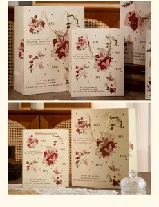 Detail view of vintage floral gift paper bags with butterfly design and elegant rope handles.
