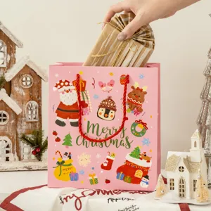 Pink Christmas gift bag featuring cute Santa cartoon, ideal for holiday packaging.
