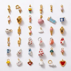 Assortimento di ciondoli smaltati placcati oro con motivi di cibo e forme graziose