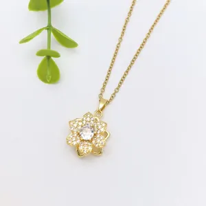 Gold flower pendant necklace with shimmering zircon stones, exquisite detail shot showing delicate chain.