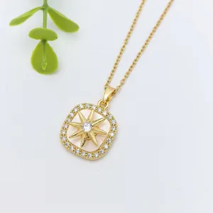 Exquisite compass star pendant necklace with sparkling cubic zirconia, elegant detail shot.