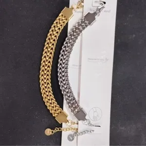 Detail shot of chic titanium steel braided chain bracelets in gold and silver, stylish.