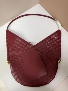 Burgundy woven leather shoulder bag with matching small pouch, soft large capacity tote.
