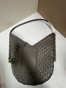 Grey woven leather shoulder bag detail showing intrecciato texture and attached pouch accessory