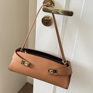 Elegant leather baguette shoulder bag with stylish metal clasp for women chic daily use.